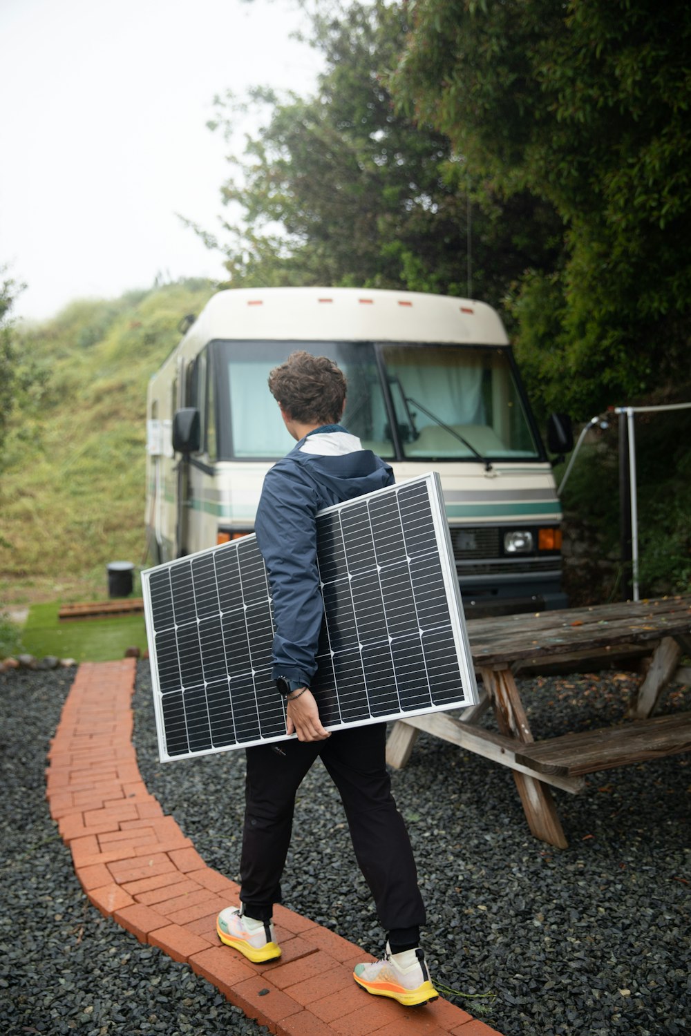 a man carrying a solar panel on his back