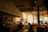 A cozy café with people enjoying their drinks and chatting happily.