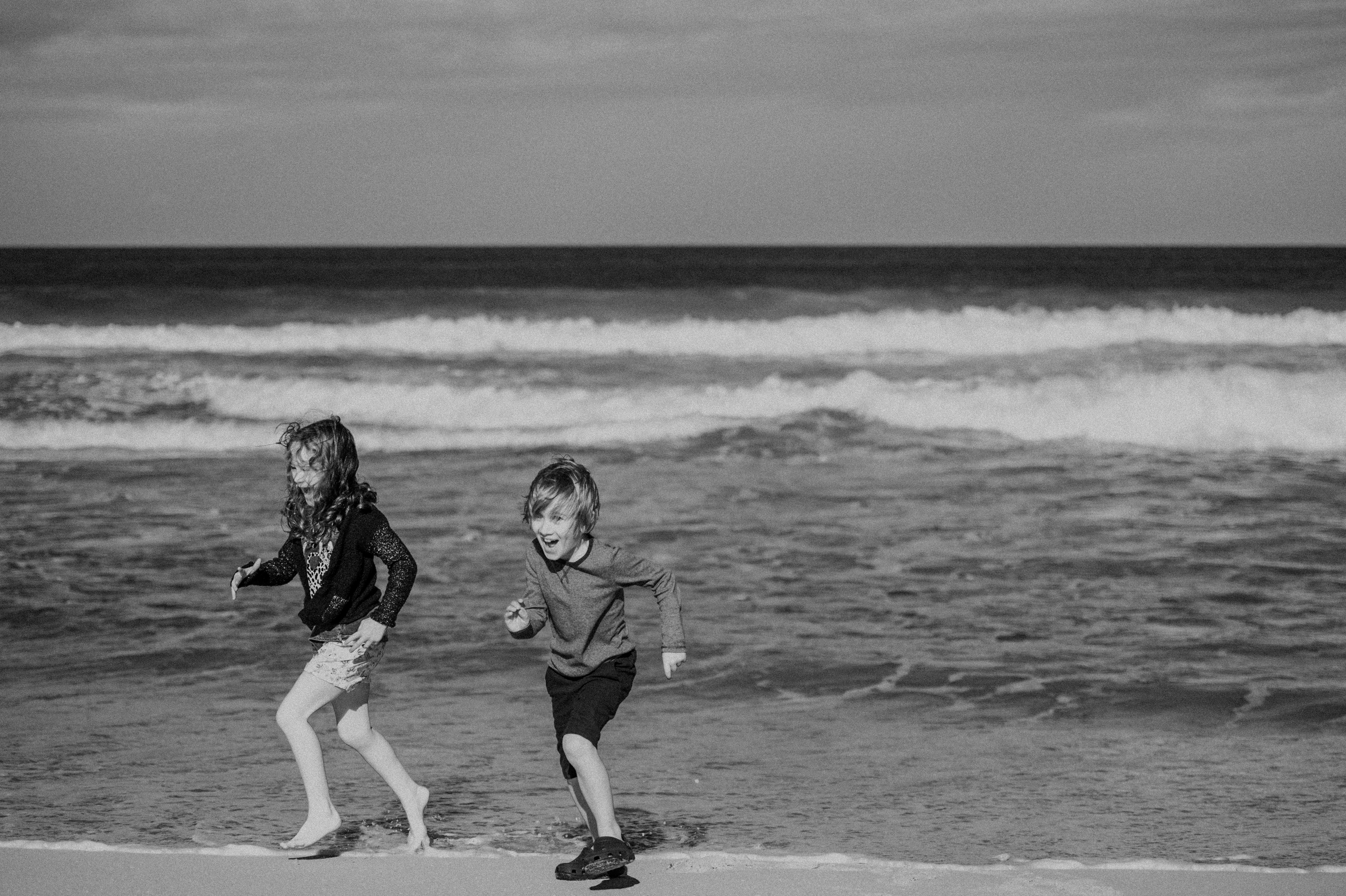 A couple of kids that are standing in the sand photo – Free Beach Image on  Unsplash, image size:3000x1997