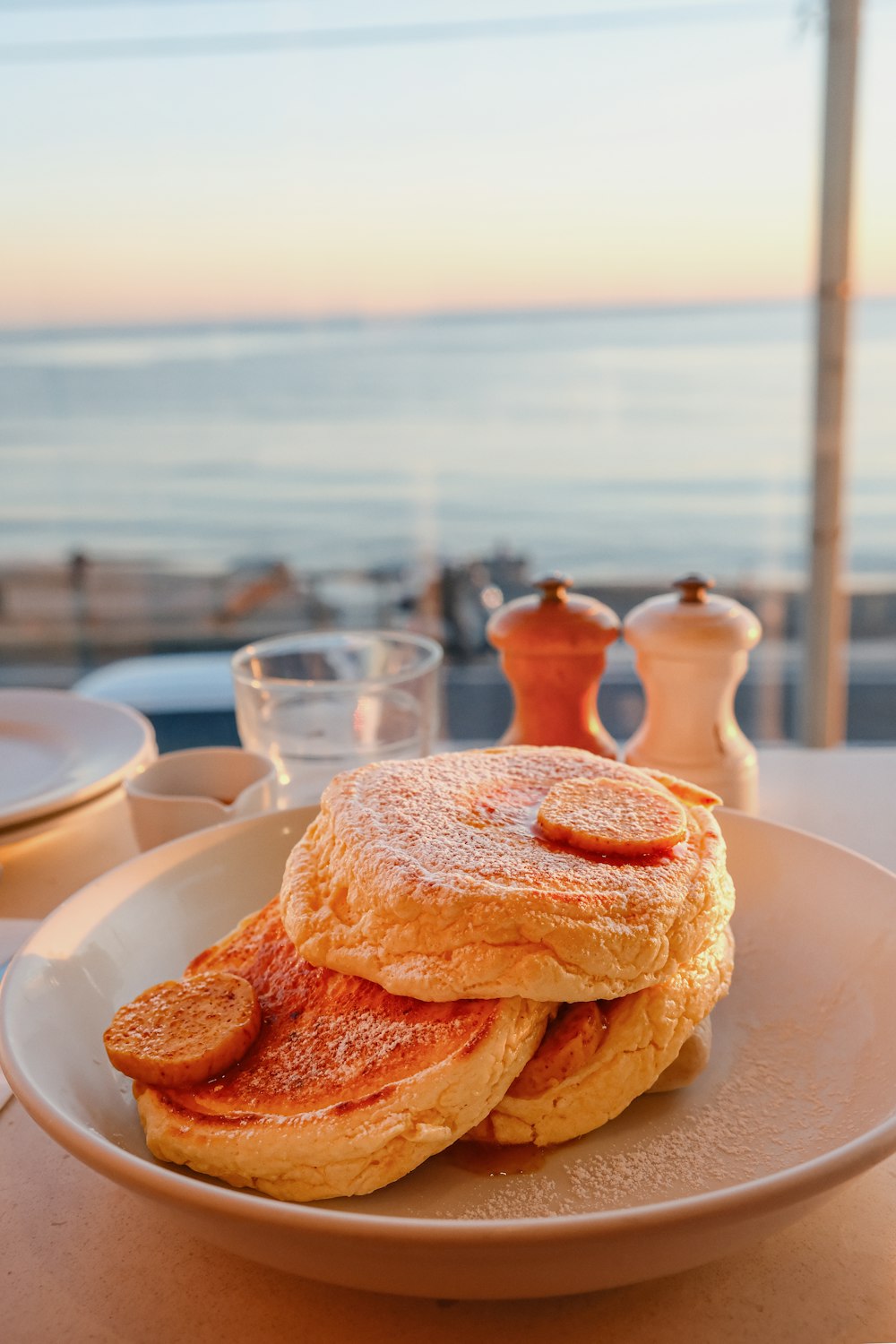 a stack of pancakes sitting on top of a white plate