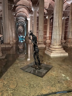 Dimly lit corner with sculptures and art installations blending with the underground music vibe.