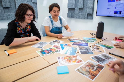 a group of people sitting around a wooden table