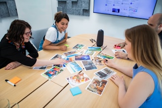 a group of people sitting around a wooden table