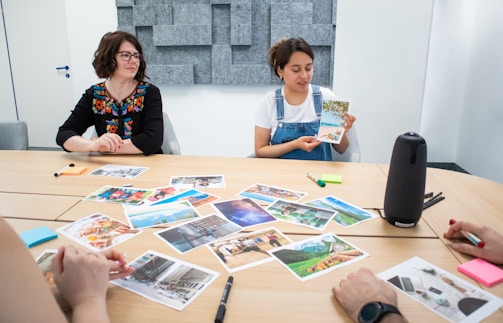 A high-resolution photo showing a diverse group of travelers discussing plans around a table with travel brochures and laptops.