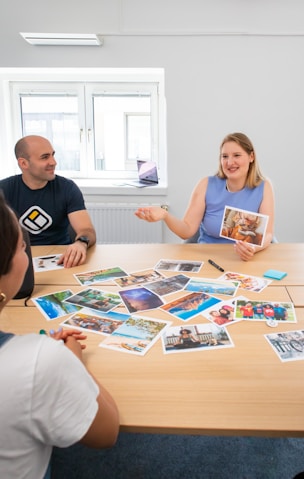 a group of people sitting around a wooden table
