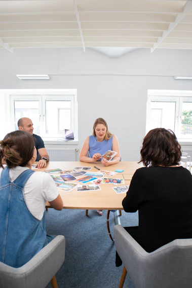 A candid photo of the foundation's board members engaged in a lively discussion during a meeting.