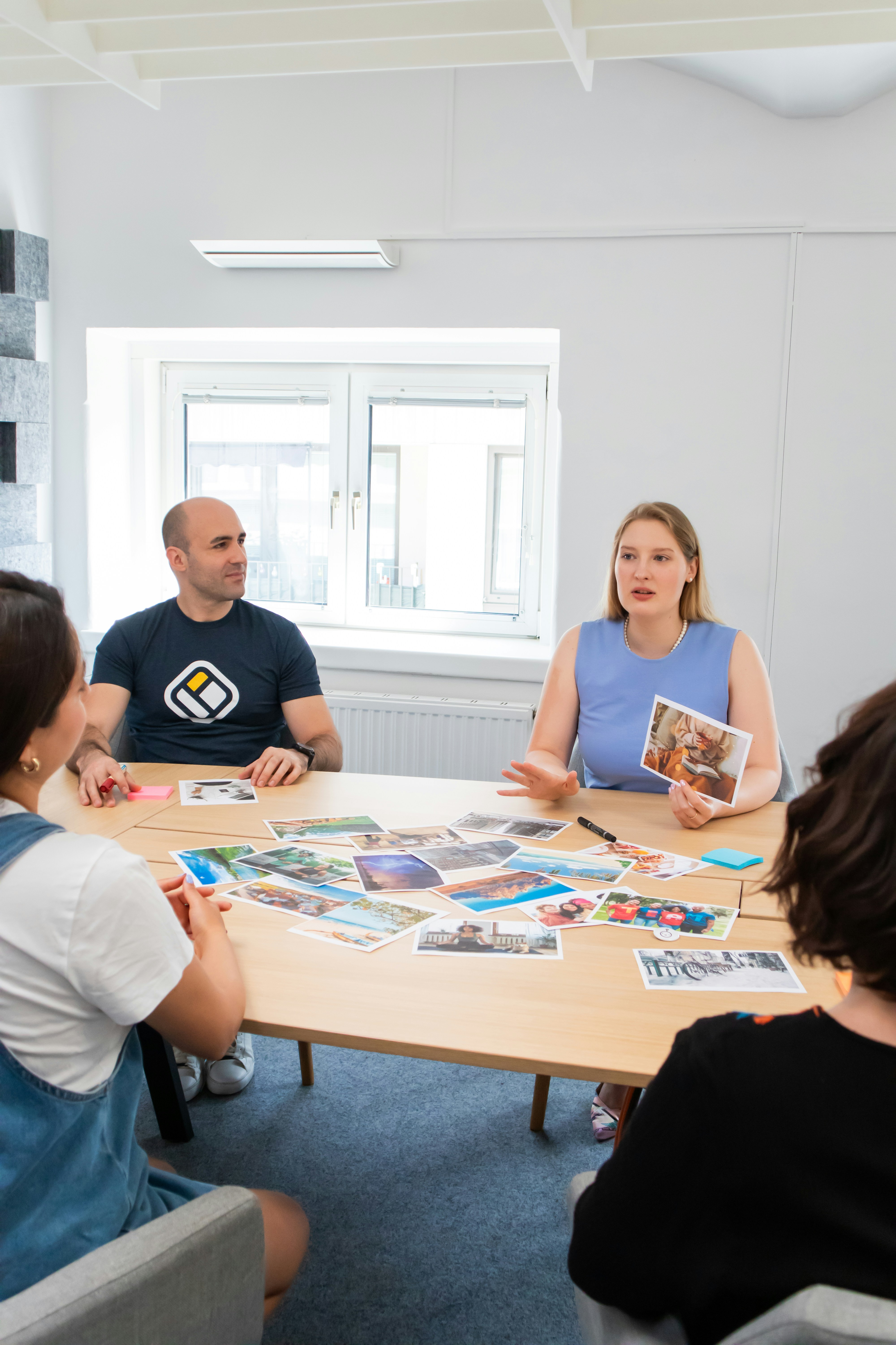 a group of people sitting around a wooden table