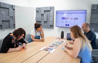A team of auditors collaborating around a conference table.