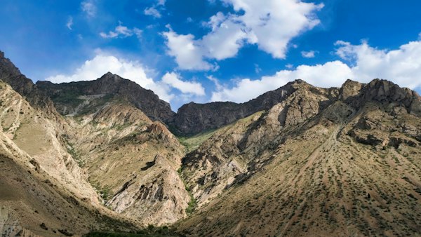 A view of a mountain range with a blue sky in the background — Pamir Highway, Tajikistan