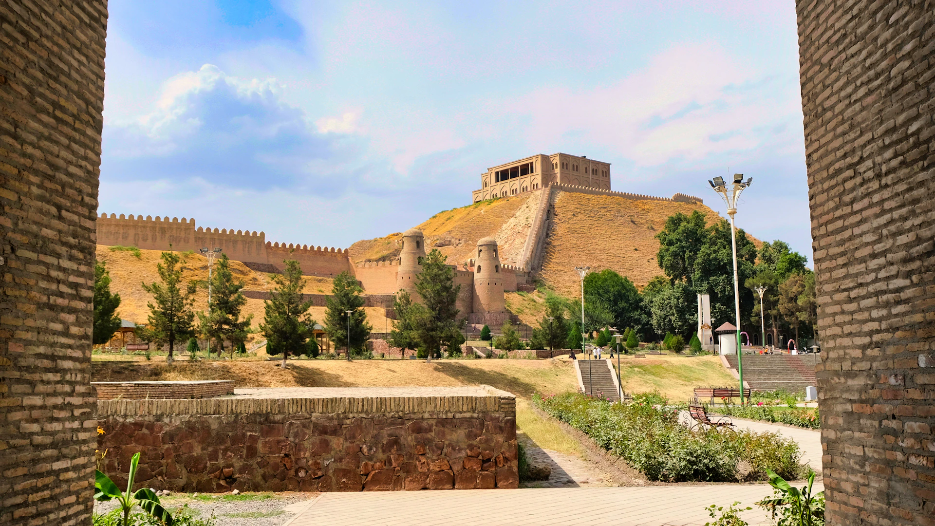 a view of a castle through two brick walls