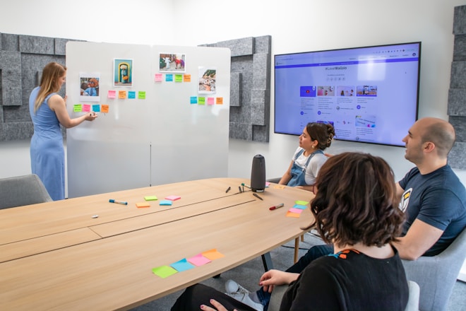 a group of people sitting around a conference table