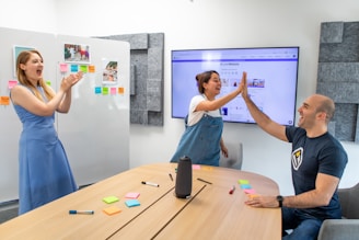 a man and a woman giving each other a high five