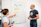 a man and a woman standing in front of a white board