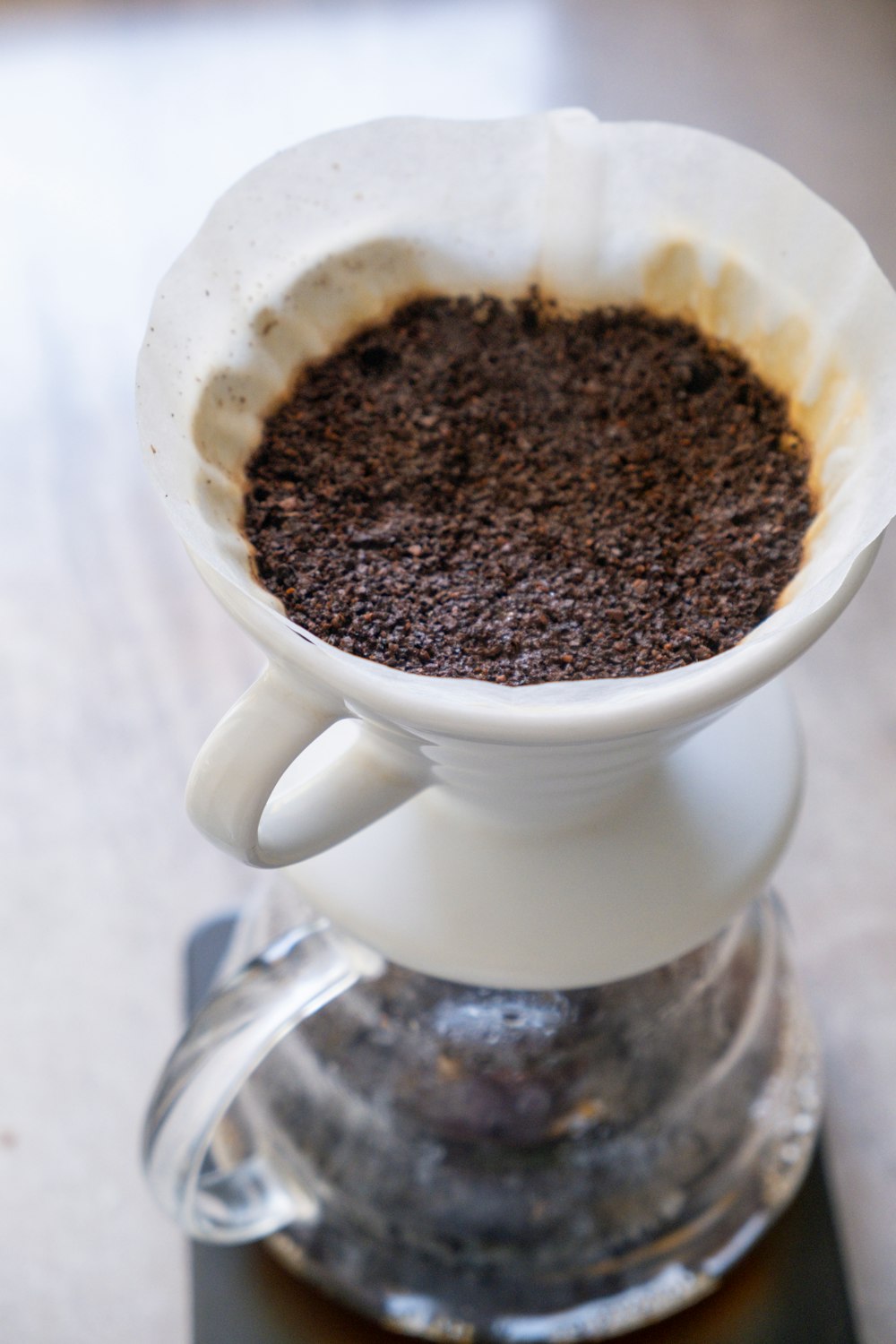 a coffee pot filled with coffee sitting on top of a coffee maker