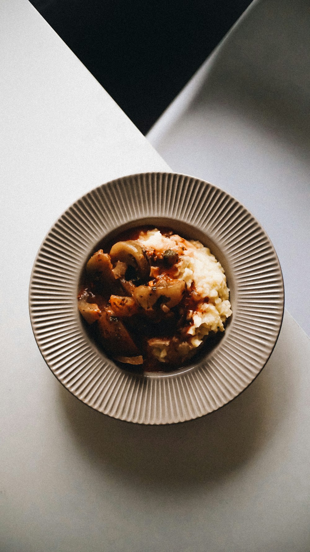 a white plate topped with mashed potatoes and meat