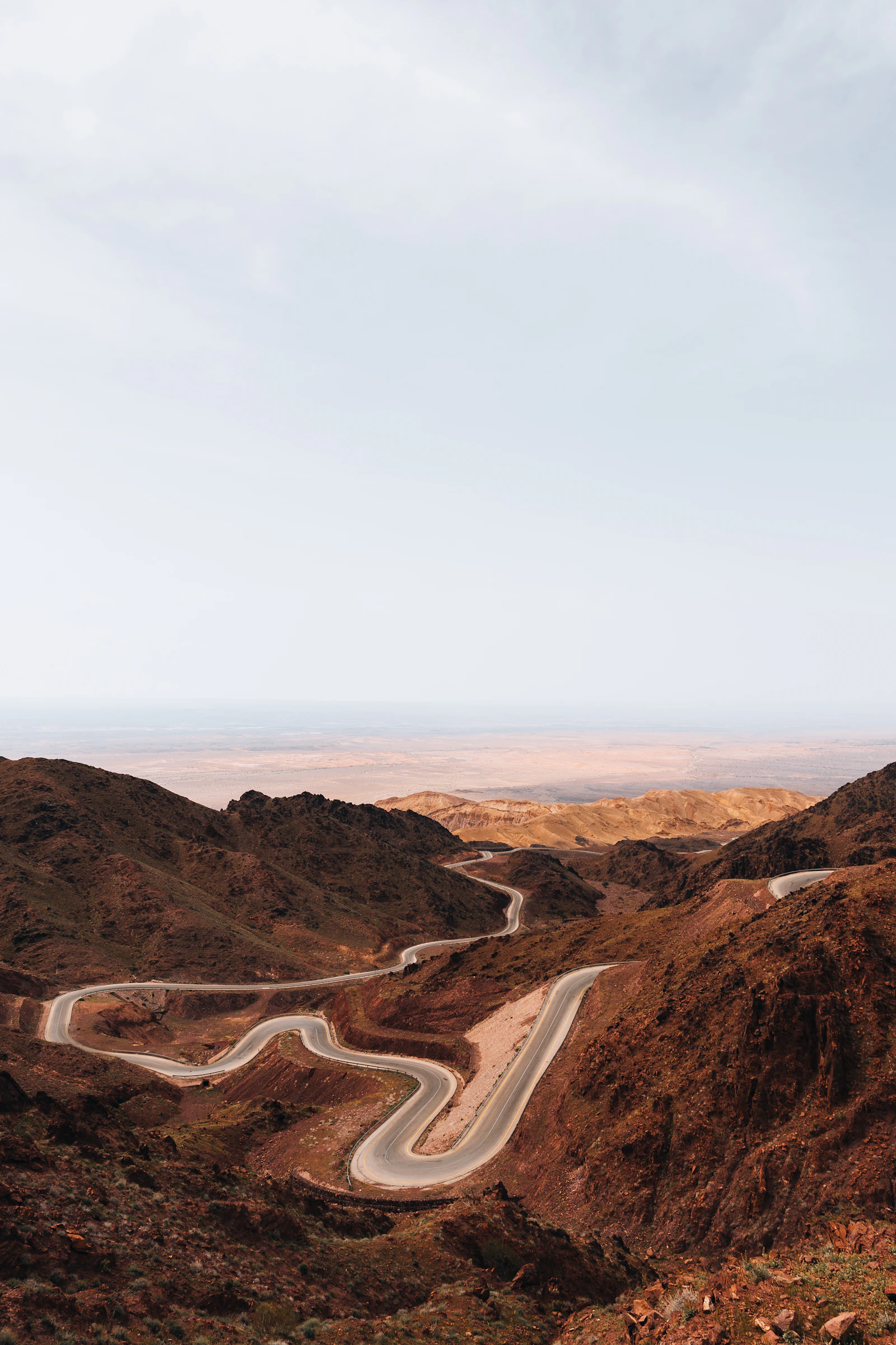 A winding road descending through Jordan's dry mountains