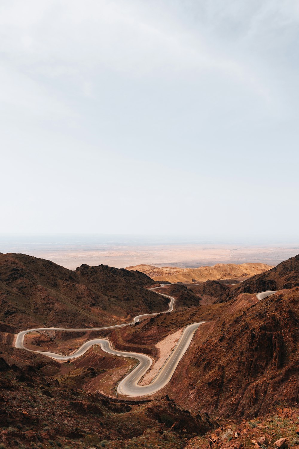 a winding road in the middle of a mountain range