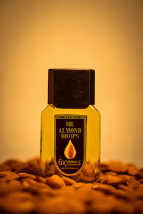 Amber glass bottle of Kesh Amrut Hair Oil with natural herbs and green leaves