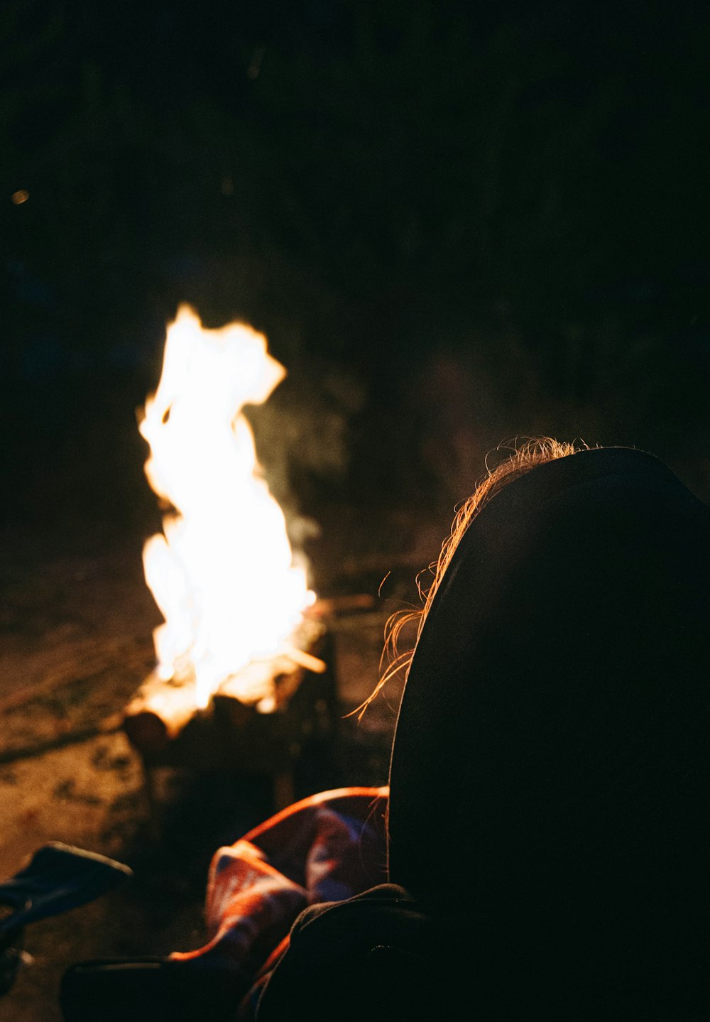 a person sitting in front of a fire