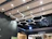 Electrician installing commercial lighting fixtures in a modern office space.