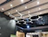 Electrician installing commercial lighting fixtures in a modern office space.