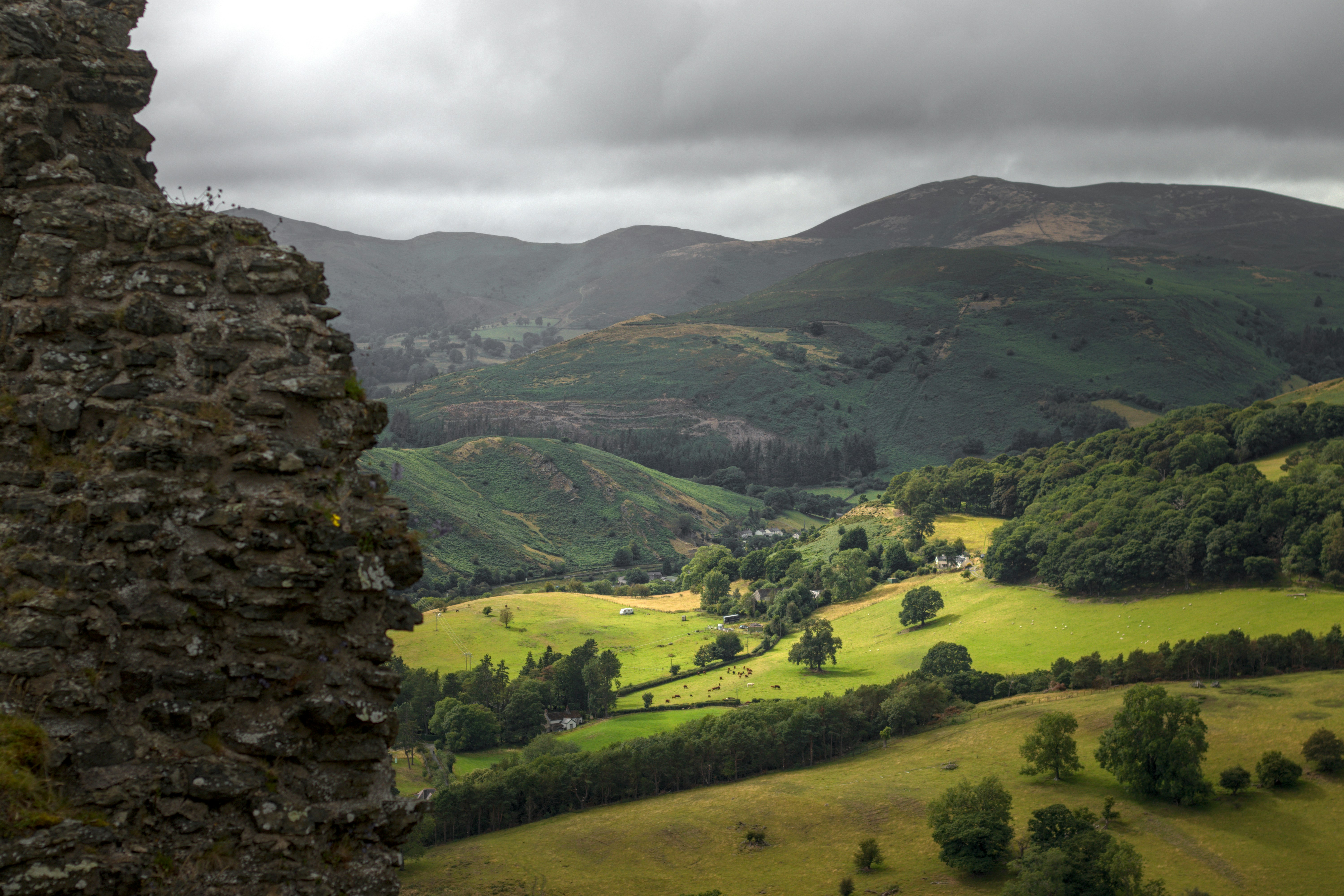a view of a valley and mountains from a tower