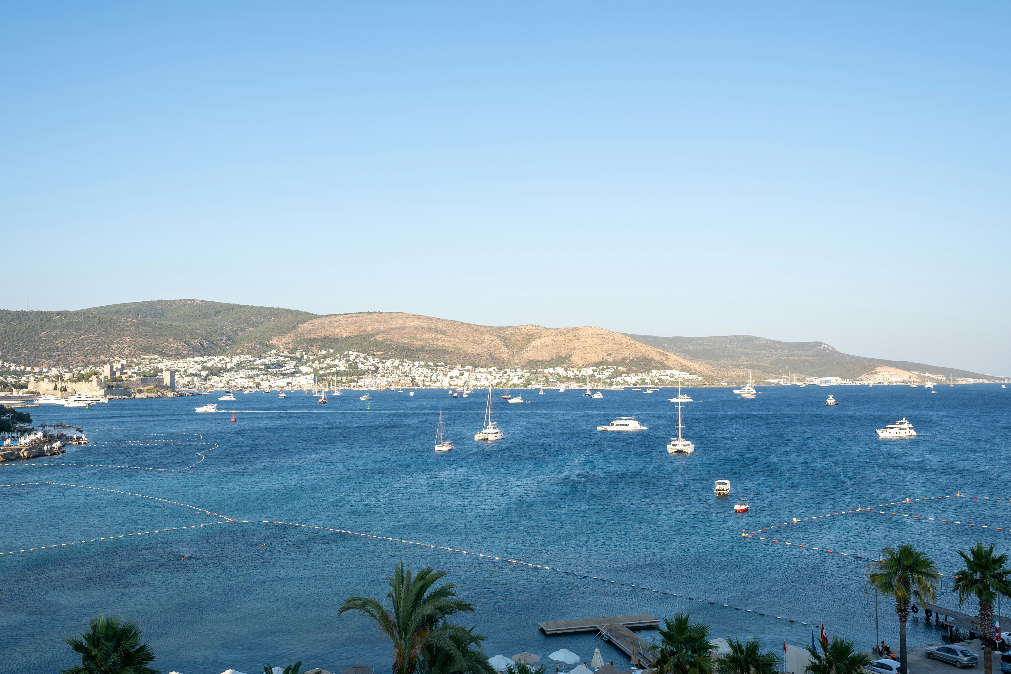 a group of boats floating on top of a body of water, vacation