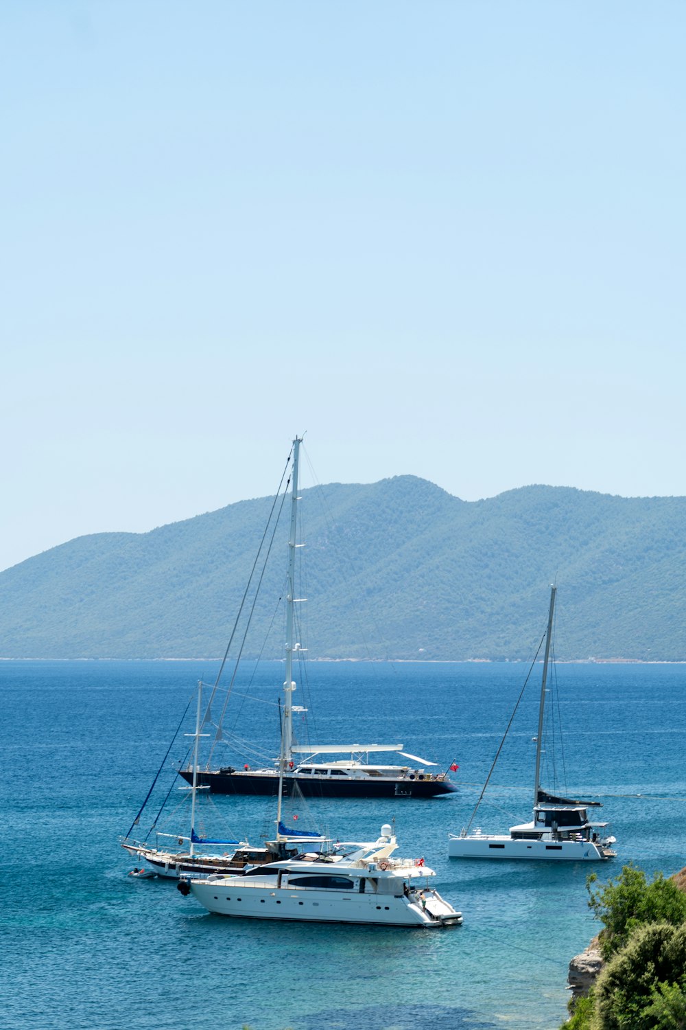 a group of boats floating on top of a body of water