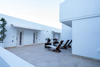 Well-kept patio with minimalist furniture and subtle greenery.