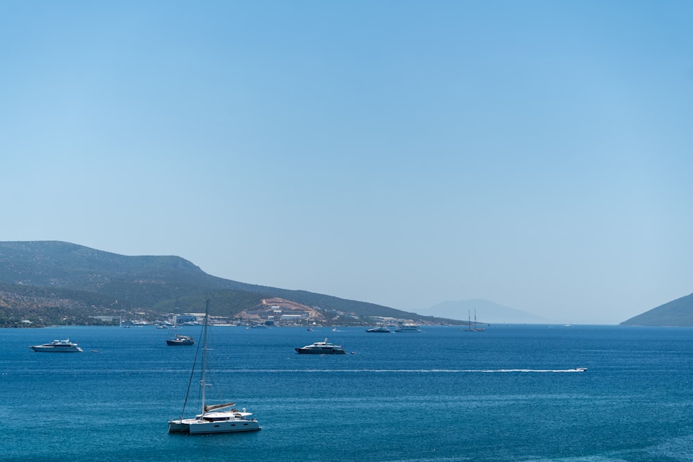 a group of boats floating on top of a large body of water