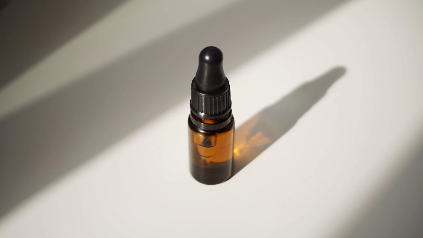 An amber dropper bottle in warm sunlight