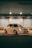 A white car with custom modifications is parked in a dimly lit urban setting. The vehicle features underglow neon lights that emit a red hue, highlighting its sporty design and aftermarket wheels. The scene has a soft blue and orange ambience due to overhead lighting.