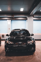 Sporty car with carbon fiber hood parked in a garage