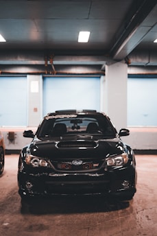 Sporty car with carbon fiber hood parked in a garage