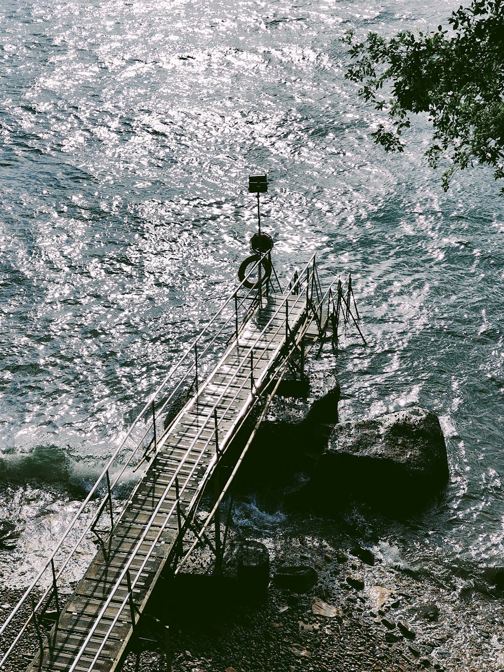 a bicycle is parked on a bridge over a body of water