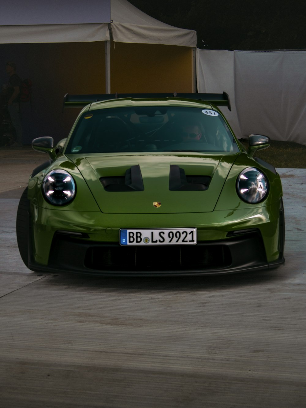 a green sports car parked in a parking lot