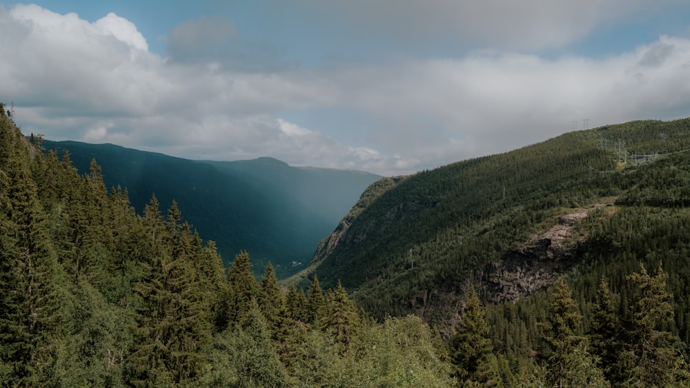 a scenic view of a mountain with a valley in the distance