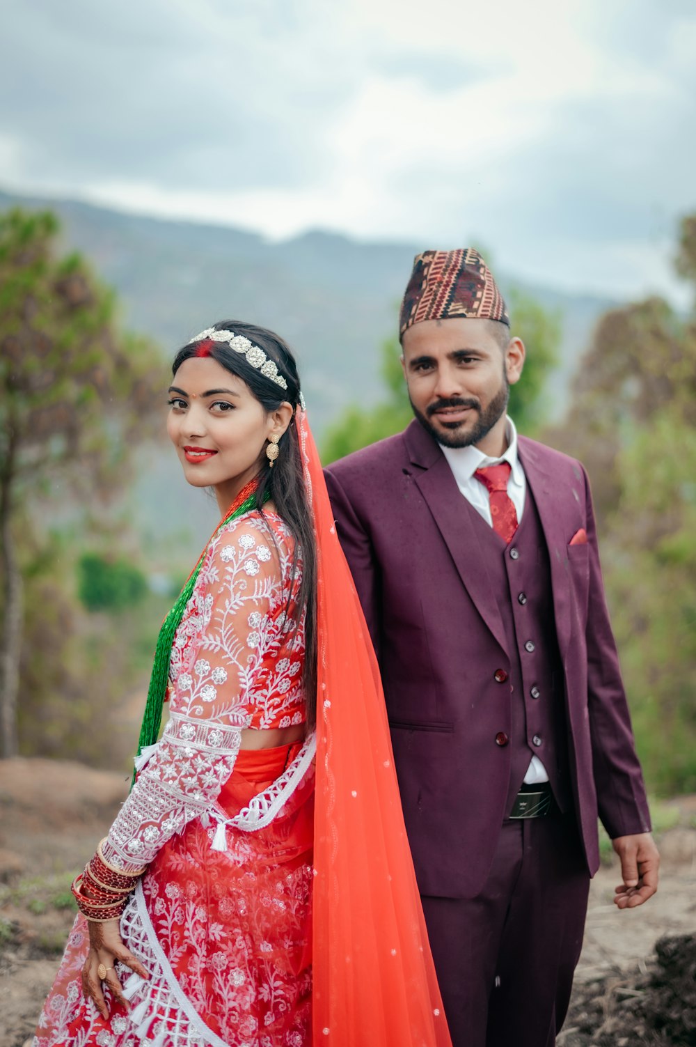 a man and a woman dressed in traditional indian garb