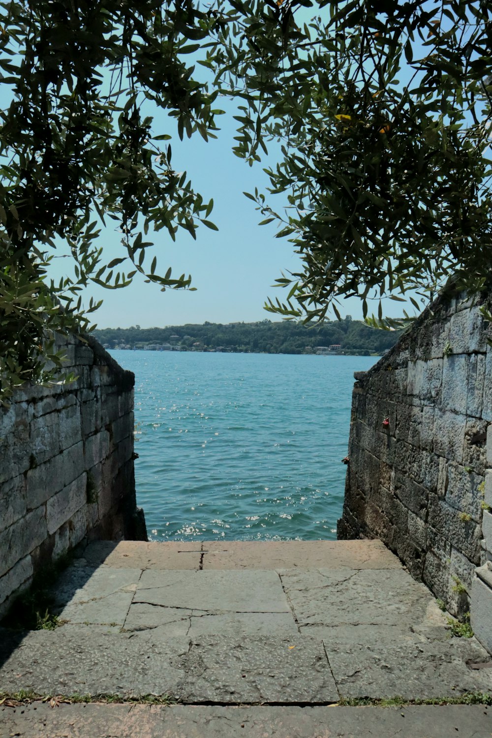 a stone walkway leading to a body of water