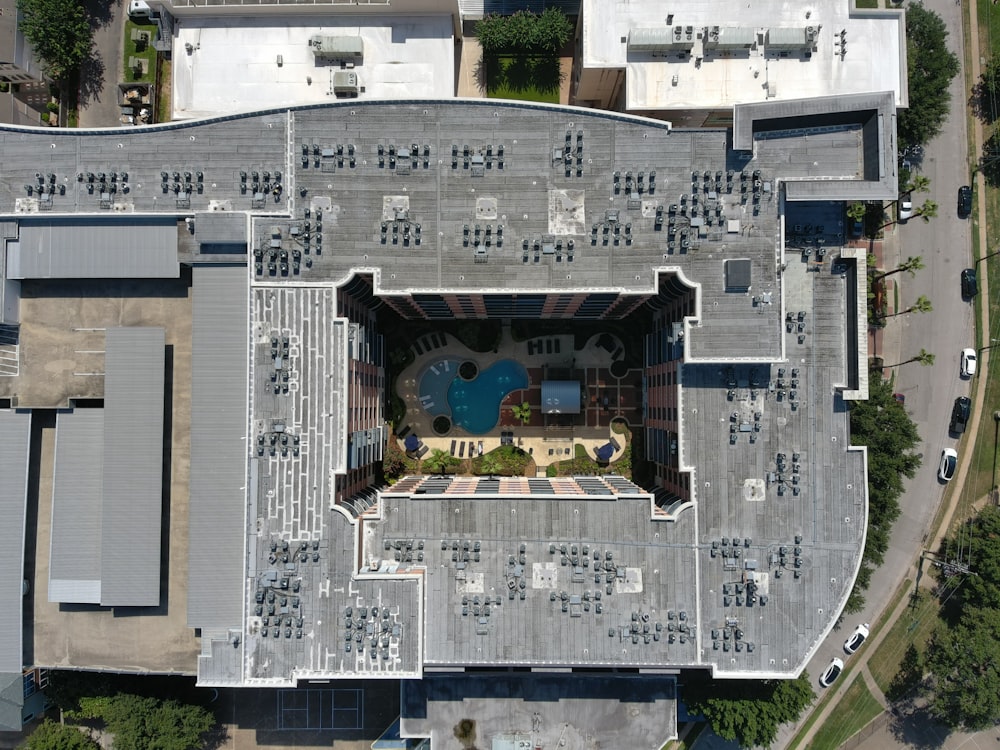 an aerial view of a building with a swimming pool