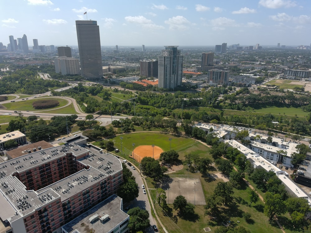 an aerial view of a city with a baseball field