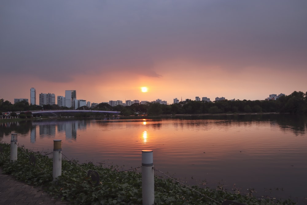 the sun is setting over a body of water