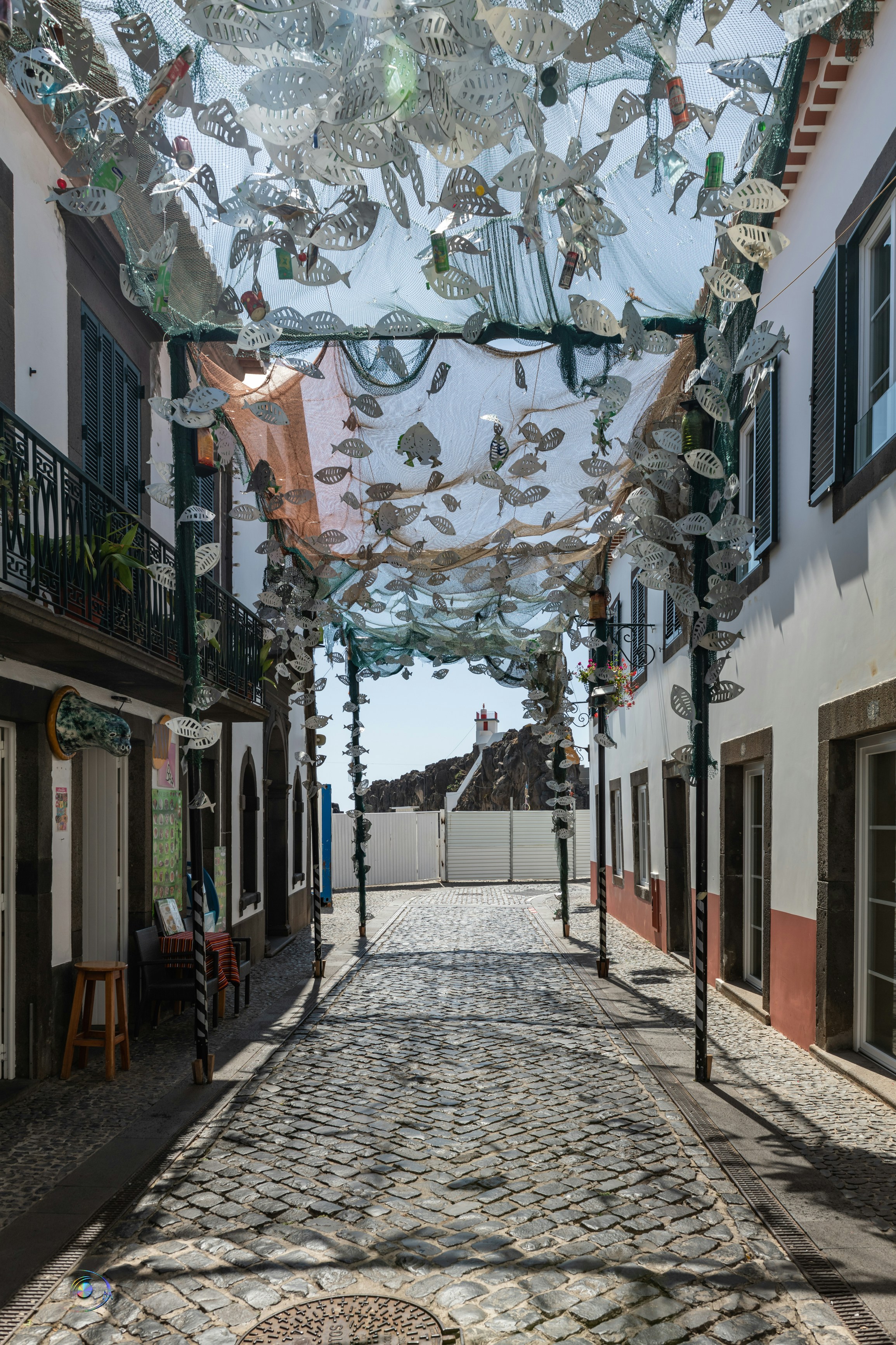 a cobblestone street lined with shops and buildings