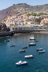 a group of boats floating on top of a body of water