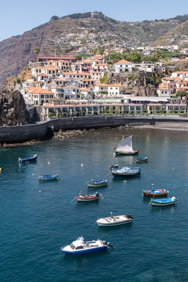 a group of boats floating on top of a body of water