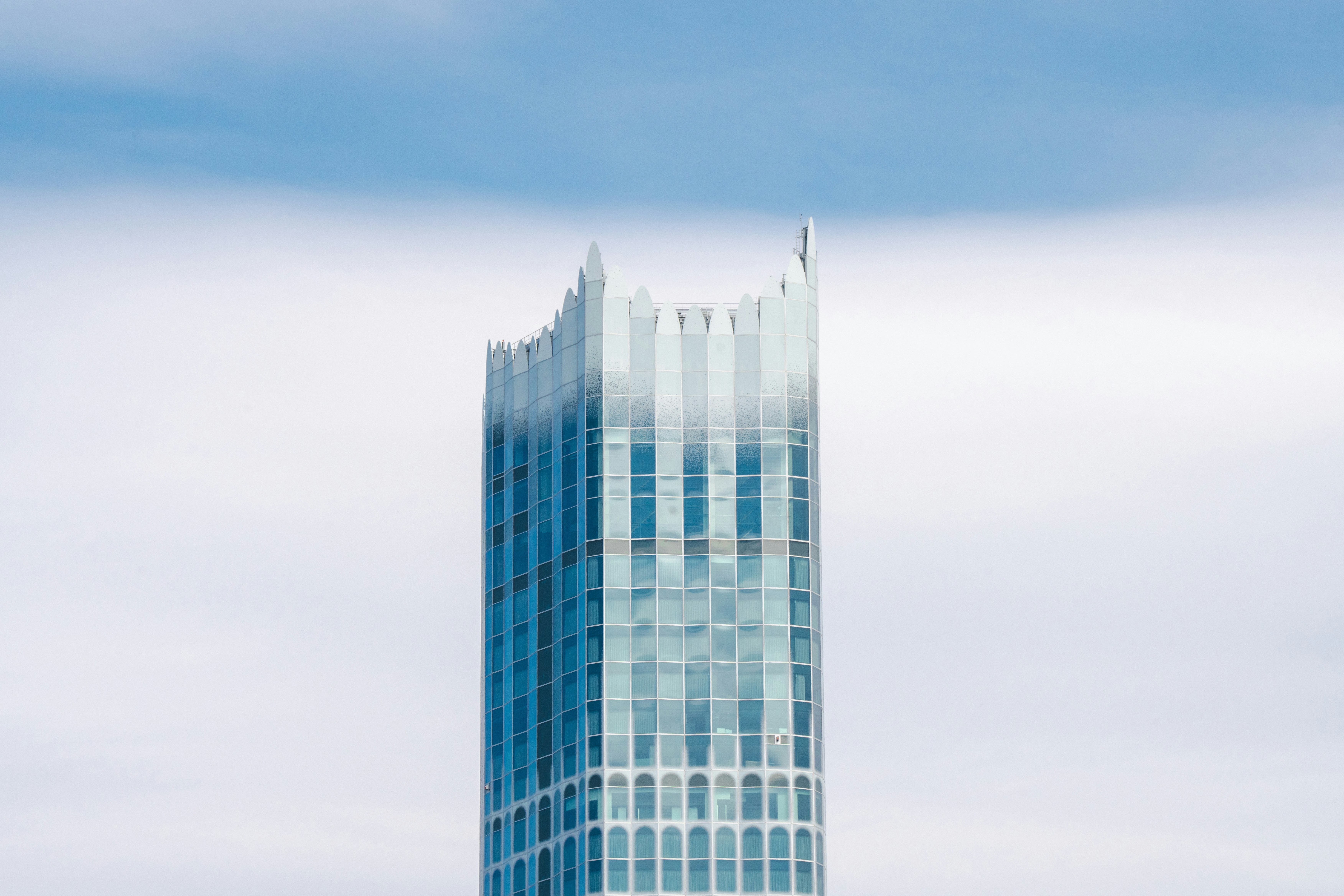 a very tall building with a sky background