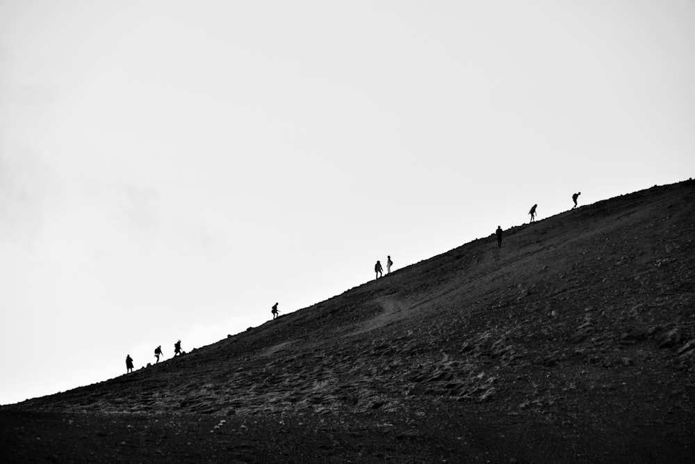 a group of people standing on top of a hill