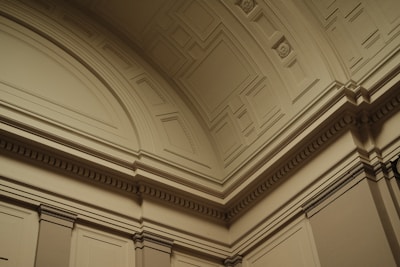 the ceiling of a building with a clock on it