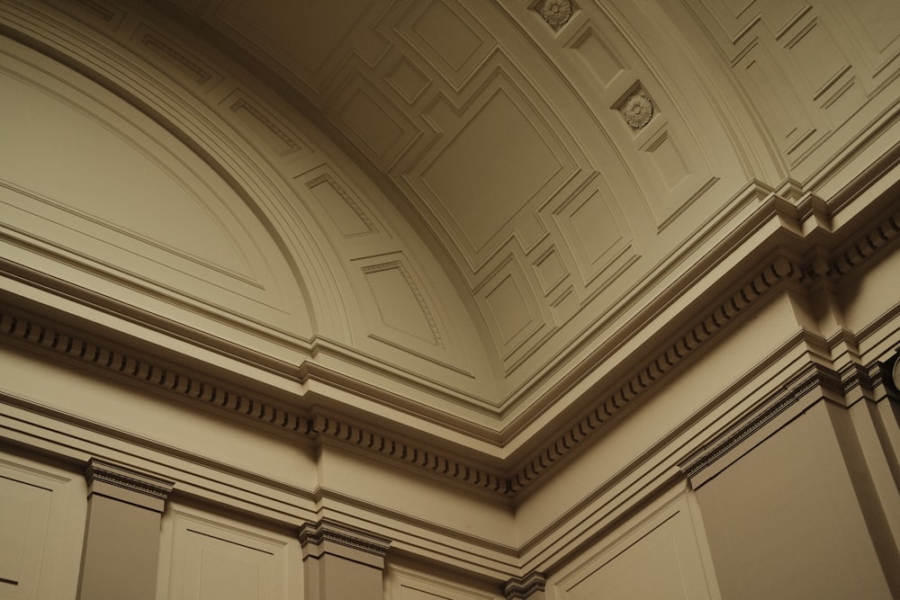 the ceiling of a building with a clock on it