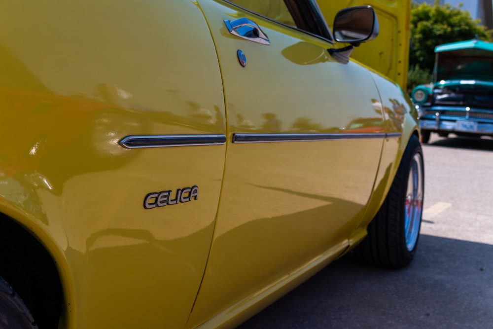 a close up of the side of a yellow car